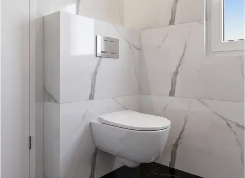 Badezimmer mit wandhängendem WC und Spülplatte